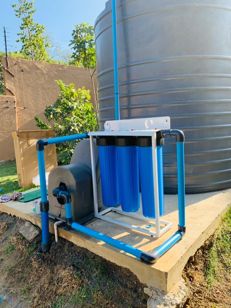 Blue water filter next to tank